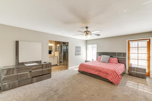 a bedroom with a bed and a flat screen tv at 12 Mi to Old Town! Home with Furnished Patio in Phoenix