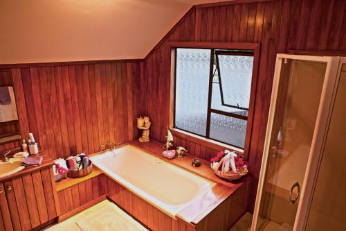 a bath tub in a room with a window at MarinaView room with private bathroom in Auckland