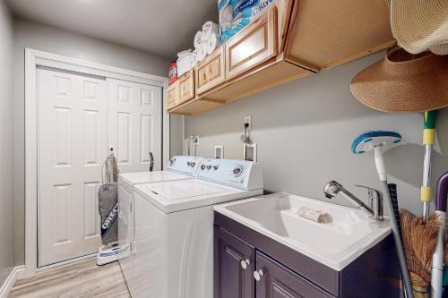 a small kitchen with a sink and a washing machine at The Lake's Hidden Gem in Snoqualmie