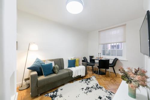 a living room with a couch and a table at kings cross St Pancras luxury apt in London