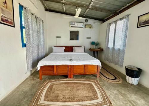 a bedroom with a bed in a room at Aqua Outback in Tuticorin