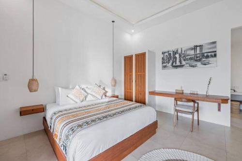 um quarto branco com uma cama e uma secretária em Villa Swantika: Infinity Pool Aussicht Canggu em Canggu
