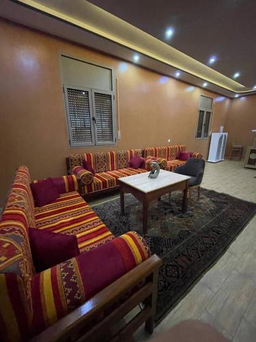 a living room with couches and a table in a room at Palms Garden in Erfoud