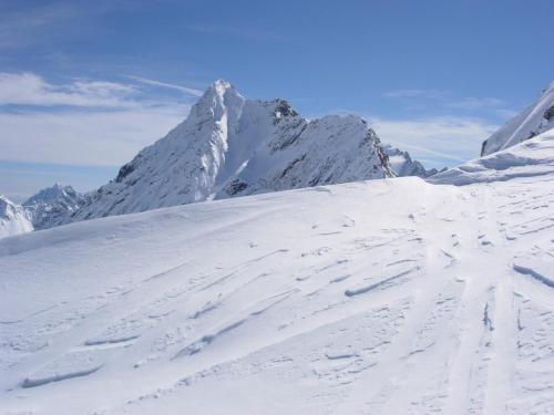 a snow covered mountain with a snow covered slope at Hotel Stella in Passo del Tonale