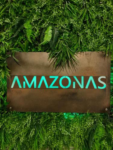 a sign that says amazon on a wall of plants at Puerto Amazonas apartamento con jacuzzi privado in El Puerto de Santa María