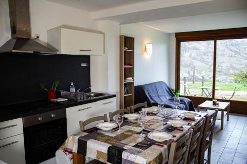 a kitchen with a table with chairs and a dining room at Cabana & Les Débuts du Ski in Les Avanchers