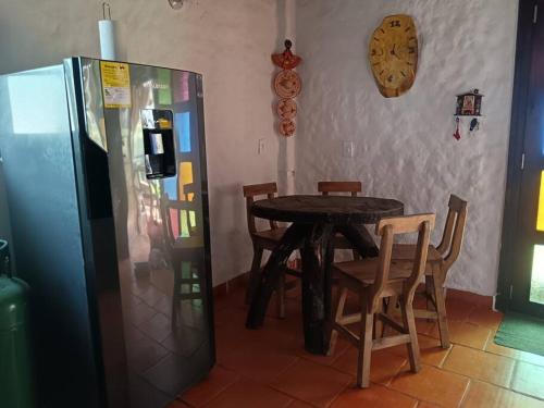 a dining room with a table and a refrigerator at Chalet MOKA la Riviera in Calima