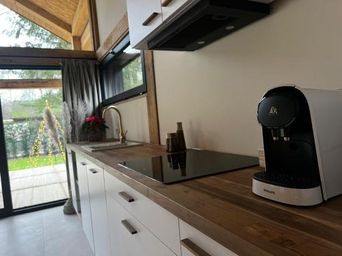 a kitchen with a coffee machine on a counter at Chalet Hoge Kempen in Zutendaal