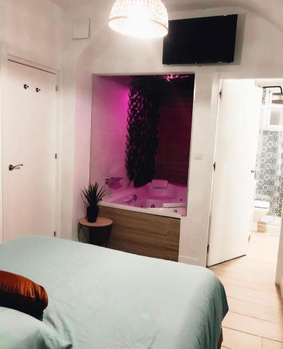 a bedroom with a purple bath tub in a window at Puerto Amazonas apartamento con jacuzzi privado in El Puerto de Santa María