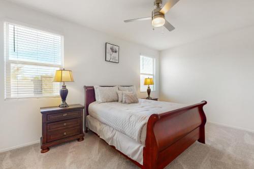 a bedroom with a bed and a nightstand and two lamps at White Orchid Sanctuary in Avondale