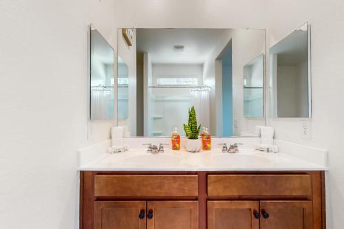 a bathroom with two sinks and a large mirror at White Orchid Sanctuary in Avondale