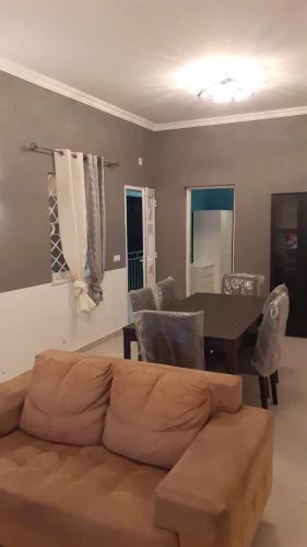 a living room with a couch and a table at VICTORIA HOSTEL in Canavial