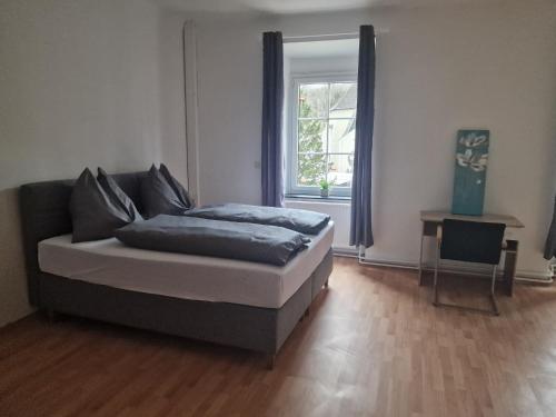 a bed sitting in a room with a window at Gudzevic Ferien Unterkünfte A - 5 in Gloggnitz