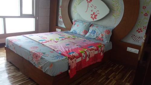 a bedroom with a bed with a blanket and pillows at Ezhimala cruise in Nīleshwar