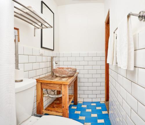 a bathroom with a wooden table and a sink at Aaki Hotel in Las Peñitas