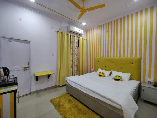 a bedroom with a bed with two stuffed animals on it at Yellow Inn Guest House in Lucknow