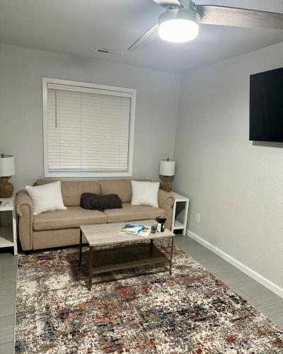a living room with a couch and a table at New, Fun-Size Benbow House! in Garberville