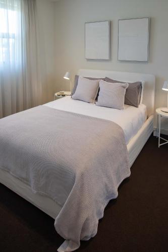 a large white bed with two pillows on it at Luxury Norwood Retreat in Norwood