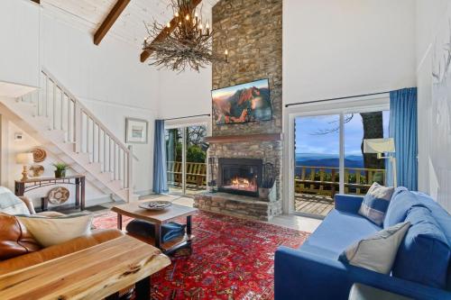 a living room with a blue couch and a fireplace at Blue View Chalet in Blowing Rock