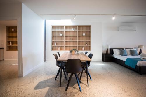 a room with a dining table and a bed at The Diggs in Anglesea