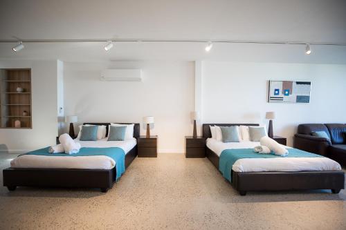 a room with two beds and a couch at The Diggs in Anglesea