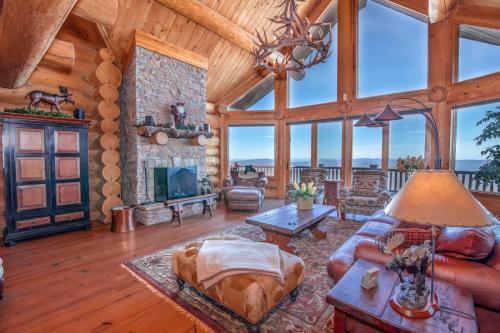 a living room with a stone fireplace and a couch at Mansion In The Sky in Beech Mountain