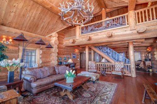 a living room in a log cabin with a couch and a table at Mansion In The Sky in Beech Mountain