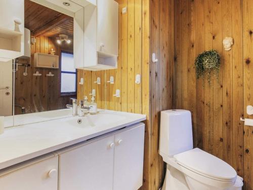 a bathroom with a toilet and a sink and a mirror at 6 person holiday home in Løkken-By Traum in Løkken
