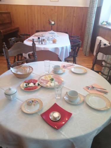 a white table with plates of food on it at Dom "Honorat", Kamianna 70, 33-336 in Kamianna