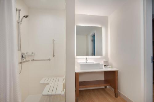 a white bathroom with a sink and a mirror at Element Atlanta Buckhead in Atlanta