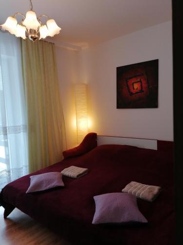 a bedroom with a large red bed with two pillows at Dom "Honorat", Kamianna 70, 33-336 in Kamianna