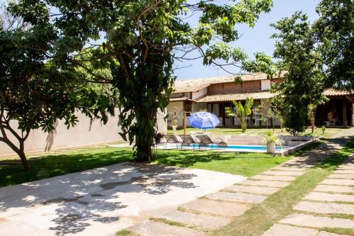 a villa with a swimming pool and a house at Casa das Pedras in Lagoa Santa