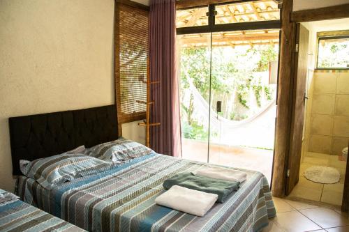 a bedroom with a bed with two towels on it at Casa das Pedras in Lagoa Santa