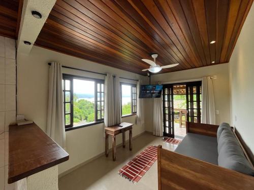 a living room with a couch and a ceiling fan at BEAUTIFUL VIEW in Angra dos Reis