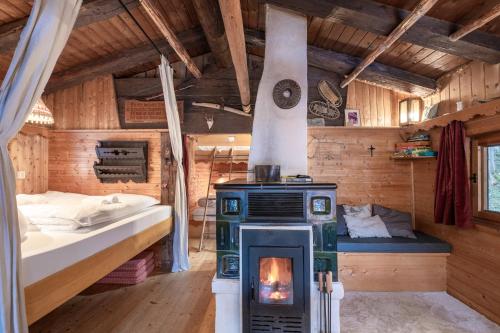 a bedroom with a stove and a bed in a room at Kitzkopf Hütte in Mayrhofen