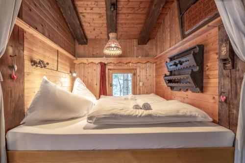 a bedroom with a bed in a wooden cabin at Kitzkopf Hütte in Mayrhofen