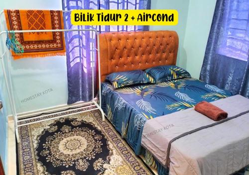 a bedroom with a bed and a mirror at Homestay Kota, Kuala Terengganu FREE WIFI in Kuala Terengganu