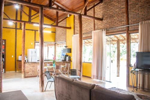 a living room with a couch and a dining room at Casa das Pedras in Lagoa Santa