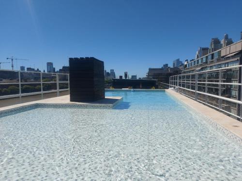 a swimming pool on the roof of a building at Alquiler Puerto Madero in Buenos Aires