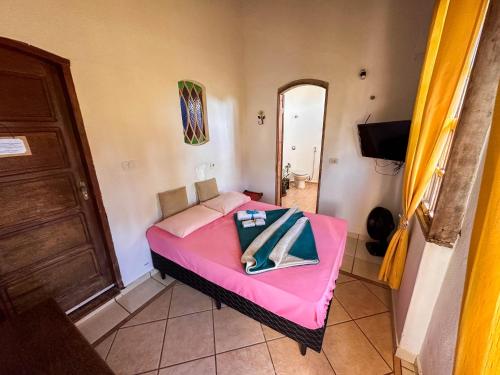Ένα ή περισσότερα κρεβάτια σε δωμάτιο στο Pousada Vale das Primaveras