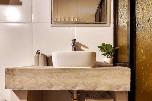 a bathroom sink with a faucet on a counter at Charming Cabaña on the beach in Cambutal