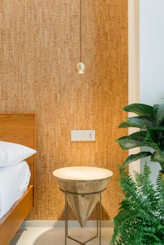 a bedroom with a table next to a bed at Porta D'Oro Charming House II & Spa in Alghero