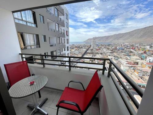 a balcony with a table and two chairs and a view at Arriendo departamento Amunategui in Iquique