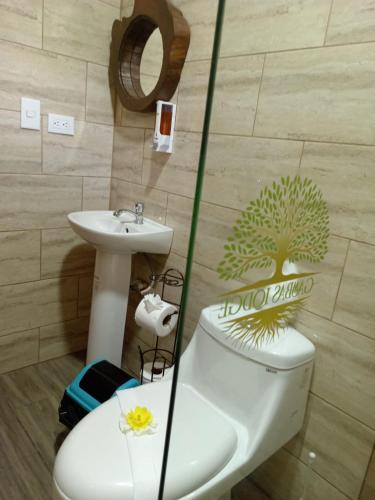 a bathroom with a toilet and a sink at Gambas Lodge in Fortuna
