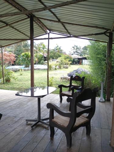 a patio with two chairs and a table under a tent at PosadaManduka Eco-Hostel in Villavicencio