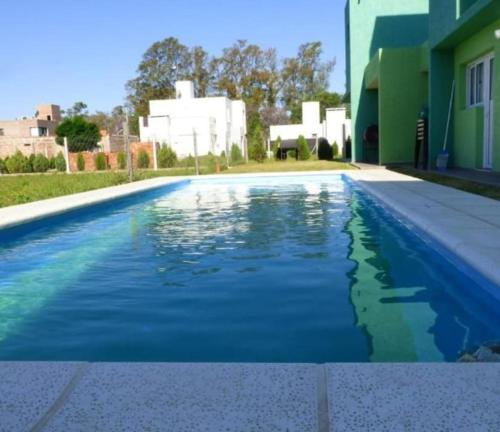 einen Pool mit blauem Wasser vor einem Haus in der Unterkunft La Francisca in Almafuerte