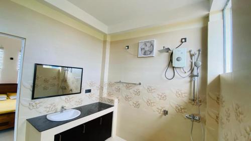 a bathroom with a sink and a shower at villa24.trinco in Trincomalee