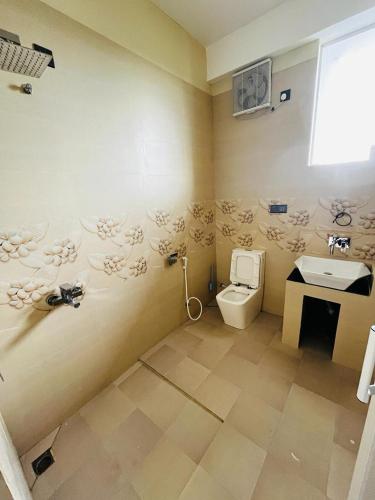 a bathroom with a toilet and a sink at villa24.trinco in Trincomalee