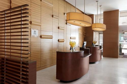 un vestíbulo con una fila de escritorios y luces colgantes en Sheraton Tribeca New York Hotel, en Nueva York