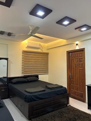 a bedroom with a bed and a ceiling fan at AL-MANAL 304 premium Room 5Beds in Bhatkal